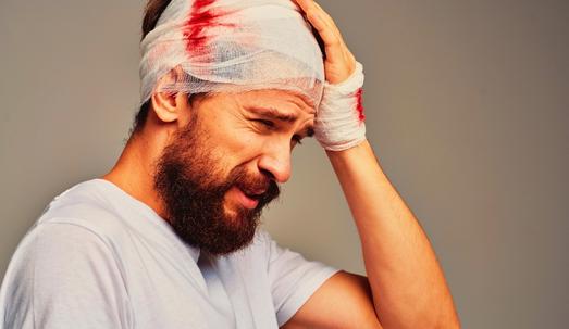 Man with bandage on head due injury causing concussion