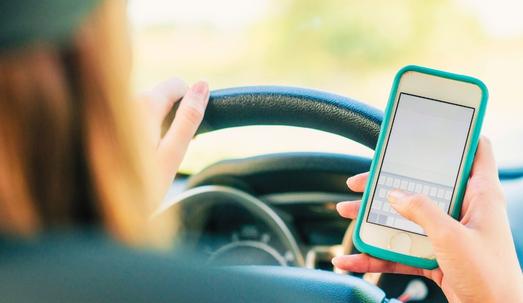 Woman using cellphone while driving