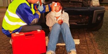 paramedic caring for an injured woman after a car accident