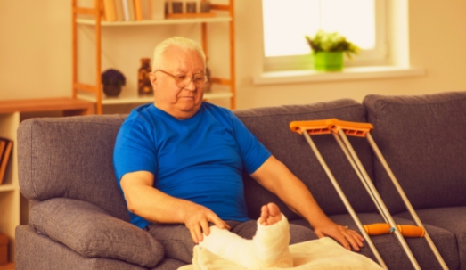 Senior man with a broken leg after a nursing home accident