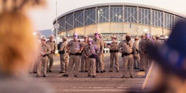 Security personnel on the street outside a stadium
