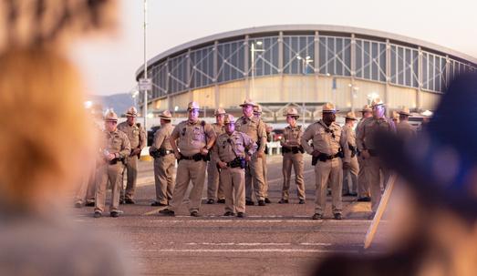 Security personnel on the street outside a stadium