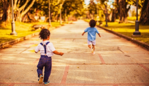 Two Children Running on Road