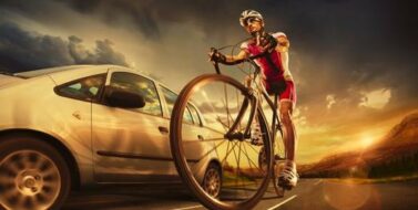 Scenic shot of a cyclist with a car passing through his side