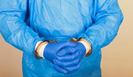 Doctor is handcuffed after a medical malpractice