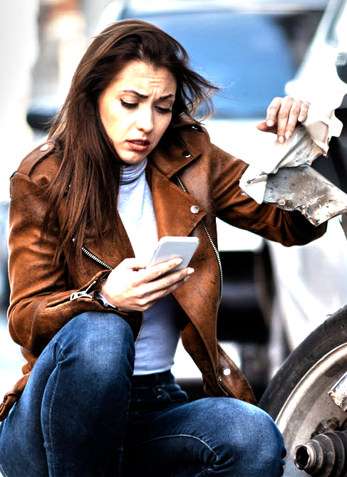 Woman looking at rideshare app after a car accident