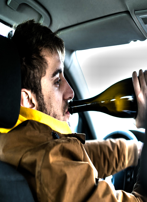 Man drinking alcohol while driving