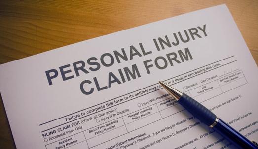 personal injury claim form with a pen on top