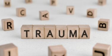 Trauma - words from wooden blocks with letters, physical or mental injury trauma