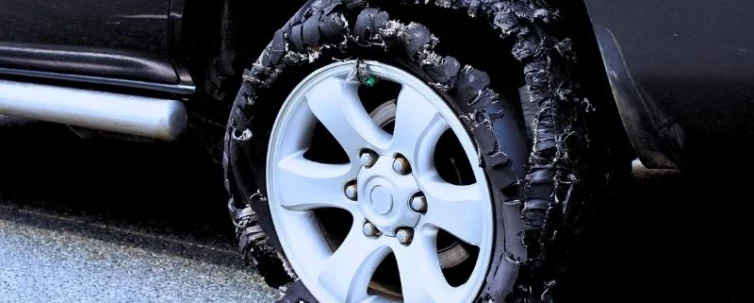 Damaged truck tire after tire explosion at high speed. Is a tire blowout an at fault accident