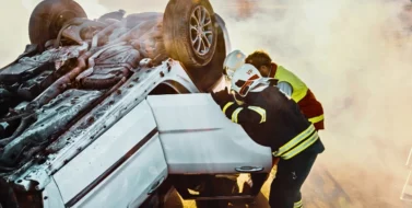 On the Car Crash Traffic Accident Scene: Rescue Team of Firefighters Pull Female Victim. Reckless Driving