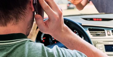 Driver calling using smartphone in car is going to hit pedestrian. Parking-Lot Pedestrian Crashes