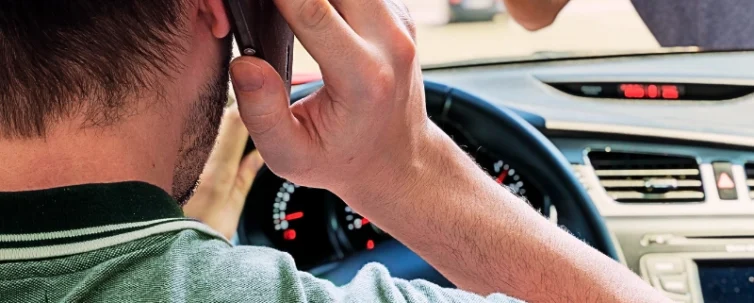 Driver calling using smartphone in car is going to hit pedestrian. Parking-Lot Pedestrian Crashes