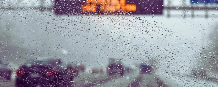 Hazardous weather condition on the road seen through windshield. weather affects car accident liability