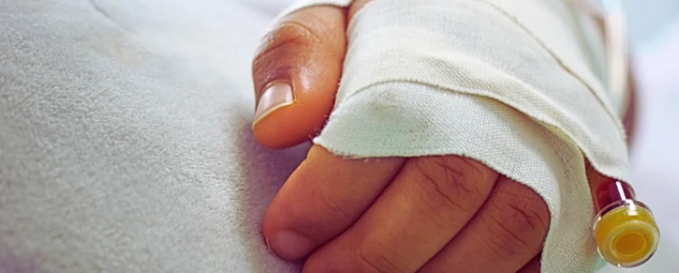 Baby's hand with bandage. Medical Mistakes During Delivery