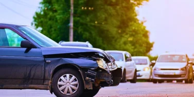 Damaged in car accident vehicle on city street crash site. Why Car Accident Evidence Disappears