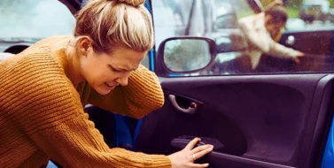 Female Motorist In Crash For Crash Insurance Fraud Getting Out Of Car. Shared Fault in Illinois Car Accidents