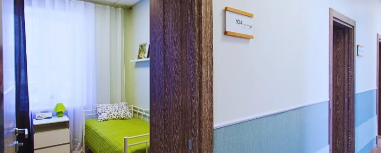 A hallway with several doors on the right side, each with a room number sign.