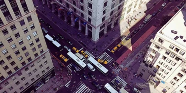 Surrounding the intersection are tall buildings, and there are yellow taxis and other vehicles navigating the streets. Fault in Chicago Intersection Accidents