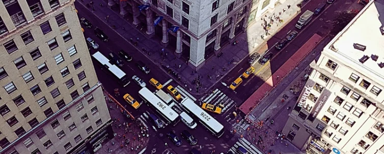 Surrounding the intersection are tall buildings, and there are yellow taxis and other vehicles navigating the streets. Fault in Chicago Intersection Accidents