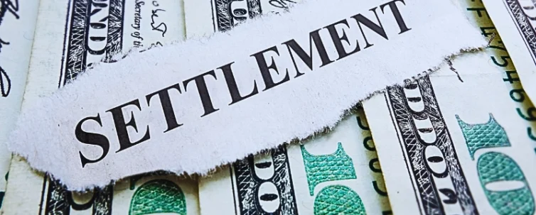 The word "SETTLEMENT" printed on a torn piece of paper placed over several U.S. hundred-dollar bills. Low Settlement Offers