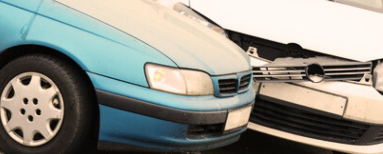 White crash damaged after a left turn accident with a blue car